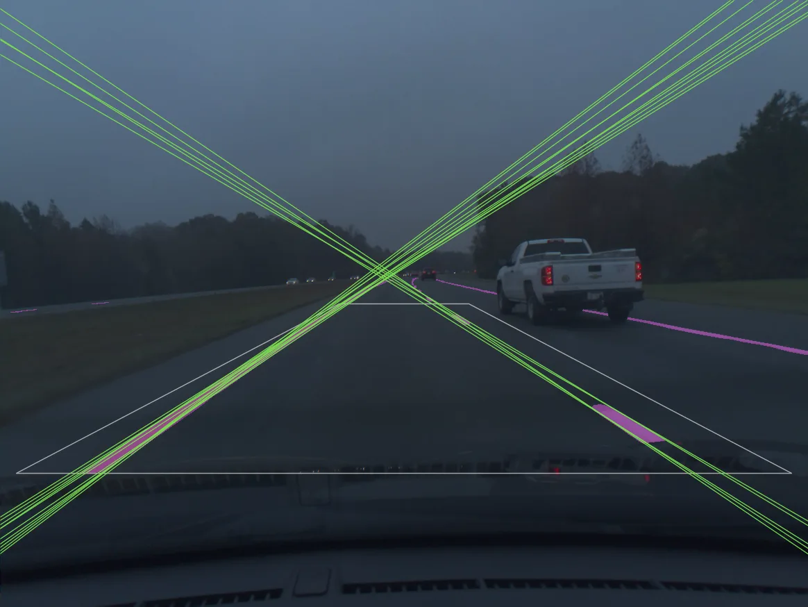 The highway frame with fifteen green lines in two fans crossing near the horizon, and the hand-painted lane markings in magenta under them