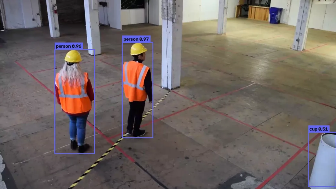 modern-yolonas predictions on a work-zone frame: two workers detected at 0.96 and 0.97, and a white pipe misread as a cup at 0.51